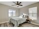 Bright bedroom features a ceiling fan, wood-look flooring, and sunny windows that provide a cozy atmosphere at 9526 Summer Furnace St, Las Vegas, NV 89178
