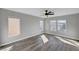A light bedroom featuring wood floors, neutral walls, and modern windows at 9526 Summer Furnace St, Las Vegas, NV 89178