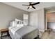 Cozy bedroom with wood-look flooring and an ensuite, offering style and convenience at 9526 Summer Furnace St, Las Vegas, NV 89178