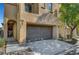 Exterior view showcasing a two car garage, complemented by drought-tolerant landscaping and walkway at 9526 Summer Furnace St, Las Vegas, NV 89178