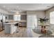 Kitchen with stainless steel appliances, gray cabinets, island with barstools, and dining area at 9526 Summer Furnace St, Las Vegas, NV 89178
