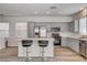 Contemporary kitchen featuring grey cabinets, stainless steel appliances, and a quartz countertop island at 9526 Summer Furnace St, Las Vegas, NV 89178