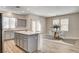 Contemporary eat-in kitchen featuring stainless appliances, quartz island with dining area, and ample counter space at 9526 Summer Furnace St, Las Vegas, NV 89178
