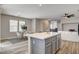 Open floor plan with eat-in kitchen with quartz island next to dining and sitting areas at 9526 Summer Furnace St, Las Vegas, NV 89178