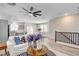 Open-concept living area with modern furnishings, stairs, and connecting dining room at 9526 Summer Furnace St, Las Vegas, NV 89178