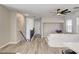 Bright, open-concept living space with updated flooring, stairs, and a ceiling fan at 9526 Summer Furnace St, Las Vegas, NV 89178