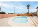 Wide backyard featuring a swimming pool, privacy walls, palm trees, and a lounge chair, perfect for enjoying the outdoors at 408 N Torrey Pines Dr, Las Vegas, NV 89107