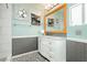 Bright bathroom featuring an updated vanity with marble countertop and large mirror, complemented by modern wall accents and fixtures at 408 N Torrey Pines Dr, Las Vegas, NV 89107