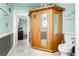 Charming bathroom featuring a wooden sauna, a modern toilet, and beautiful wall paneling with light blue paint at 408 N Torrey Pines Dr, Las Vegas, NV 89107