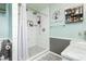 Renovated shower showcasing a modern design with gray and white tiles, a built-in niche, and dual shower heads at 408 N Torrey Pines Dr, Las Vegas, NV 89107