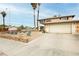 Two-story home boasts desert landscaping, a two-car garage, and a lengthy driveway at 408 N Torrey Pines Dr, Las Vegas, NV 89107