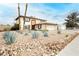 Spacious two-story home with desert landscaping and rock accents in the front yard at 408 N Torrey Pines Dr, Las Vegas, NV 89107