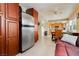 Open living space featuring a full-sized refrigerator, wood cabinets, and neutral walls at 408 N Torrey Pines Dr, Las Vegas, NV 89107