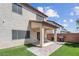 Spacious backyard featuring a covered patio, brick pavers, and well-maintained artificial turf at 10135 Haymarket Peak Ave, Las Vegas, NV 89166