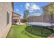 Expansive backyard with artificial turf and a large trampoline at 10135 Haymarket Peak Ave, Las Vegas, NV 89166