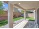 Backyard features a covered patio, artificial grass, brick wall and a trampoline, ideal for outdoor entertainment at 10135 Haymarket Peak Ave, Las Vegas, NV 89166