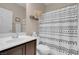 Modern bathroom features a stylish vanity, toilet, and shower with a black and white patterned curtain at 10135 Haymarket Peak Ave, Las Vegas, NV 89166
