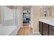 Open bathroom concept with a tub, shower, double sinks, and easy access to the main bedroom at 10135 Haymarket Peak Ave, Las Vegas, NV 89166
