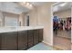 A large bathroom features double sinks, dark cabinets, and a separate walk-in closet at 10135 Haymarket Peak Ave, Las Vegas, NV 89166
