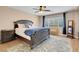 Primary bedroom with decorative bedding, dark wood furniture and natural light from large window at 10135 Haymarket Peak Ave, Las Vegas, NV 89166