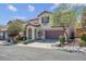 Charming two-story home featuring a two-car garage and landscaped front yard at 10135 Haymarket Peak Ave, Las Vegas, NV 89166
