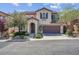 Charming two-story home featuring a two-car garage and landscaped front yard at 10135 Haymarket Peak Ave, Las Vegas, NV 89166