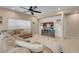 Cozy living room features a plush sectional, ceiling fan, and modern decor for comfortable living at 10135 Haymarket Peak Ave, Las Vegas, NV 89166