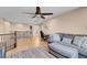 Upstairs loft with sofa, desk, laundry area, hardwood floors, with railing overlooking entry at 10135 Haymarket Peak Ave, Las Vegas, NV 89166