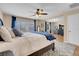 Spacious main bedroom with a ceiling fan, large window, and a blue accent rug at 10135 Haymarket Peak Ave, Las Vegas, NV 89166