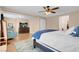 Bright main bedroom featuring a ceiling fan, tv, and a comfortable seating area at 10135 Haymarket Peak Ave, Las Vegas, NV 89166