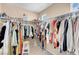 Spacious walk-in closet with built-in shelving and hanging rods for optimal organization at 10135 Haymarket Peak Ave, Las Vegas, NV 89166