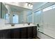 This bathroom features double sinks, vanity, a shower and tub combo with glass doors at 10241 Headrick Dr, Las Vegas, NV 89166