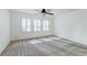 Bedroom features large windows with wooden shutters and a ceiling fan for comfort at 10241 Headrick Dr, Las Vegas, NV 89166
