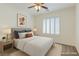 Bright bedroom with a neutral palette, a ceiling fan, and plantation shutters for privacy at 10241 Headrick Dr, Las Vegas, NV 89166