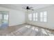 Bright bedroom with a ceiling fan, plush carpeting, and ample natural light at 10241 Headrick Dr, Las Vegas, NV 89166