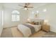 Comfortable bedroom with natural light features a ceiling fan and neutral decor at 10241 Headrick Dr, Las Vegas, NV 89166