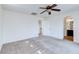 Bright bedroom has carpet, a ceiling fan, and easy access to the bathroom at 10241 Headrick Dr, Las Vegas, NV 89166