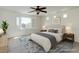 Light-filled bedroom with plantation shutters and ceiling fan offers a view from the window at 10241 Headrick Dr, Las Vegas, NV 89166