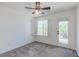 Bright bedroom with a ceiling fan, window and exterior door to the balcony at 10241 Headrick Dr, Las Vegas, NV 89166
