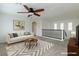 Upstairs bonus room with ceiling fan, art and a stairway, ideal for lounging or entertaining at 10241 Headrick Dr, Las Vegas, NV 89166