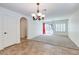 Dining area with tile flooring, and modern light fixture leading to the backyard and pool area at 10241 Headrick Dr, Las Vegas, NV 89166