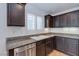 Updated kitchen with stainless steel dishwasher, dark cabinets, and granite countertops at 10241 Headrick Dr, Las Vegas, NV 89166