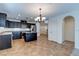 Modern kitchen with dark cabinets, granite countertops, stainless steel appliances, and eat-in island at 10241 Headrick Dr, Las Vegas, NV 89166