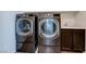 Well-equipped laundry room featuring modern washer and dryer units, and a utility sink at 10241 Headrick Dr, Las Vegas, NV 89166