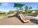 Community playground with slides and picnic tables on a sunny day at 10241 Headrick Dr, Las Vegas, NV 89166