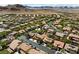 Expansive aerial view of a community nestled amongst mountains at 10281 Wolves Den Ln, Las Vegas, NV 89178