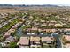 Expansive aerial view of a desert community with houses and curved streets surrounded by mountains in the background at 10281 Wolves Den Ln, Las Vegas, NV 89178