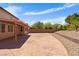 This home includes a backyard featuring a stamped concrete patio and meticulous landscaping at 10281 Wolves Den Ln, Las Vegas, NV 89178