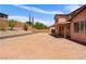 Expansive stamped concrete patio and spacious landscaped backyard with retaining wall at 10281 Wolves Den Ln, Las Vegas, NV 89178