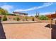 Spacious backyard with stamped concrete, retaining wall, and lush landscaping at 10281 Wolves Den Ln, Las Vegas, NV 89178